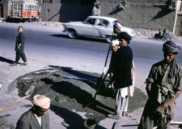 "Afghan workers make a street repair in Kabul."